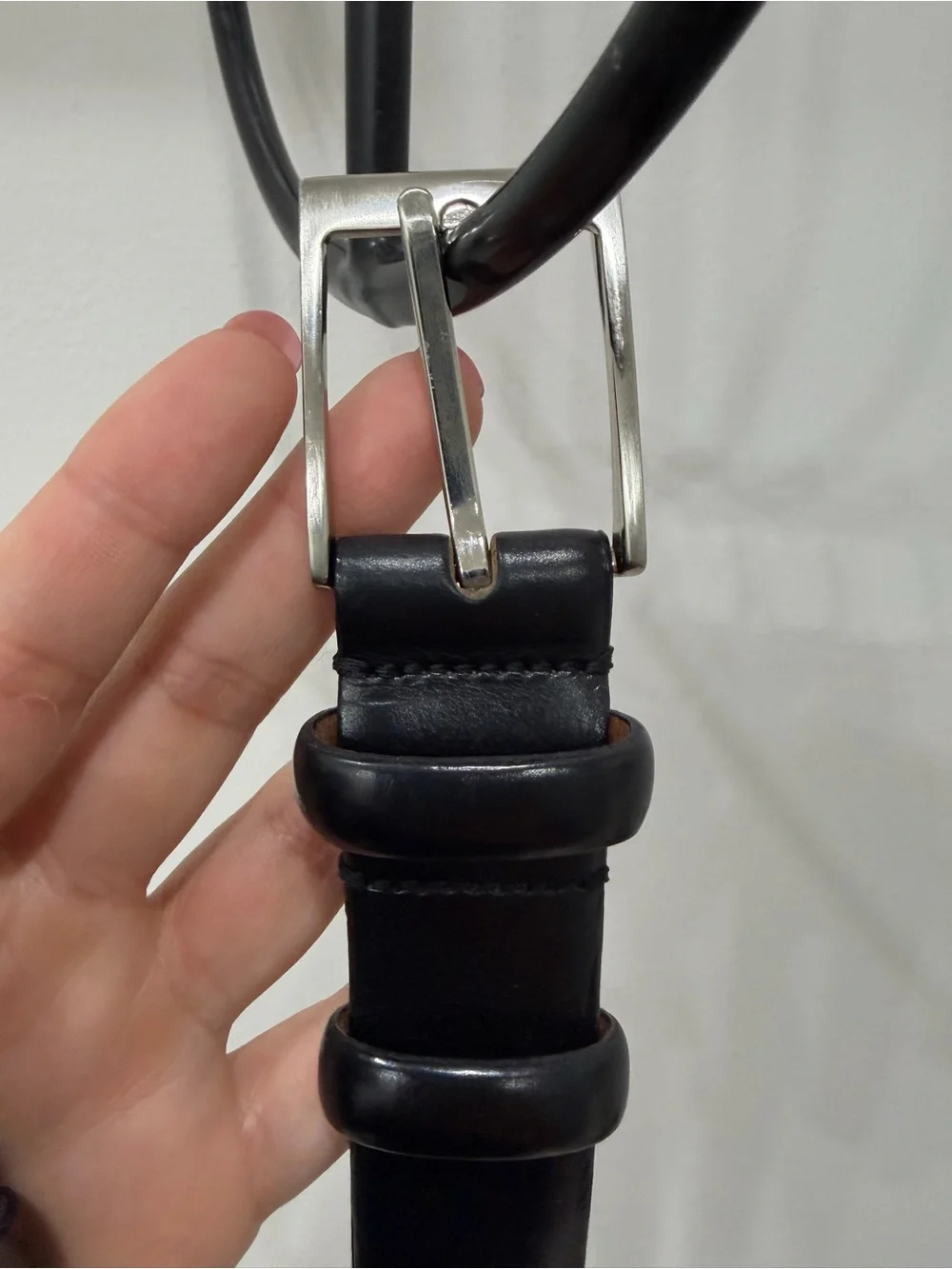 Men’s black leather belt with silver buckle